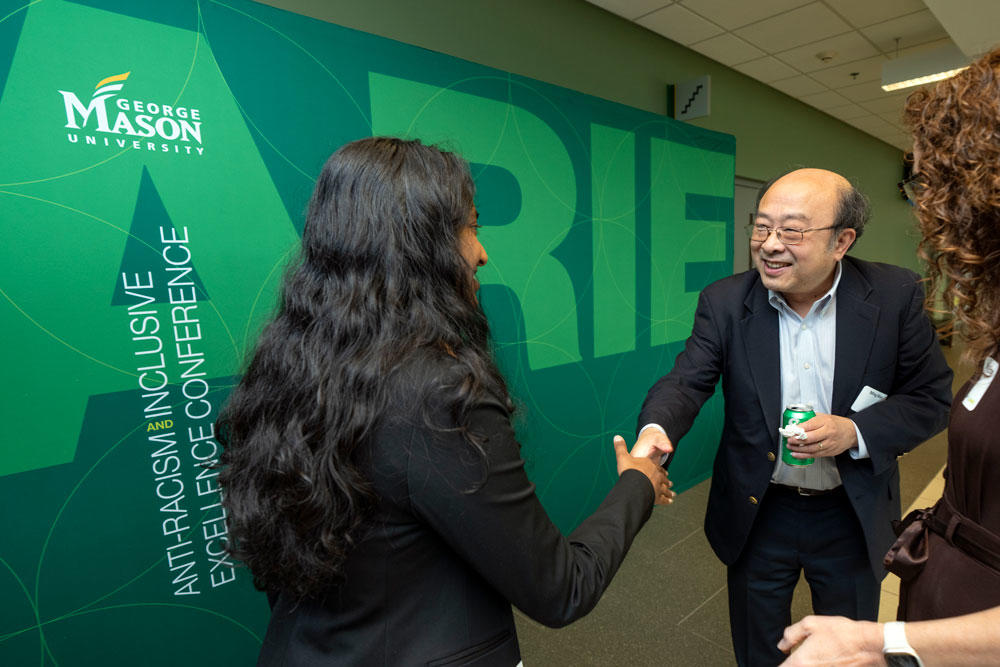 ARIE National Conference attendees shaking hands